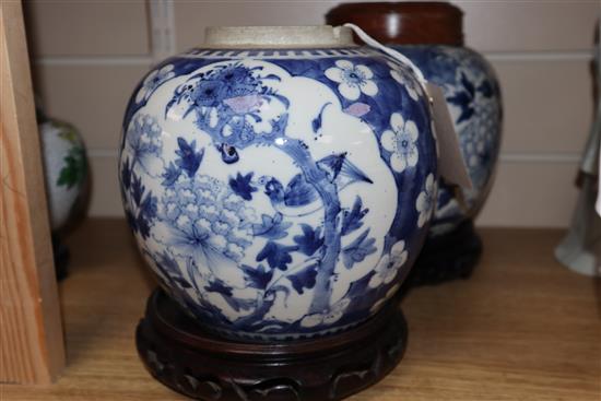 Two Chinese blue and white jars and covers and a pair of hardwood stands